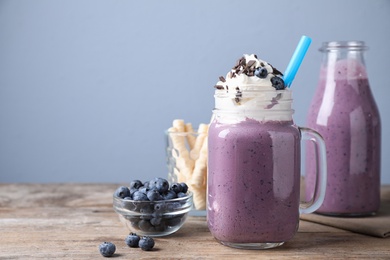 Tasty blueberry milk shake served on wooden table