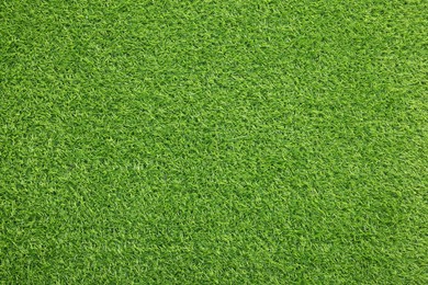 Photo of Green artificial grass as background, top view