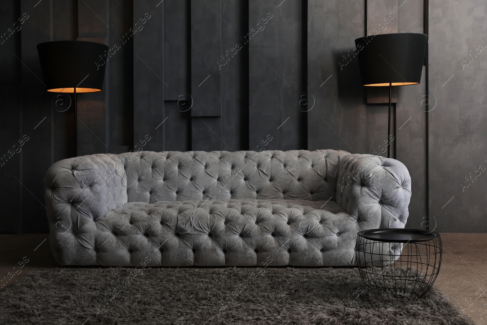 Photo of Big comfortable sofa in modern living room. Luxury interior design