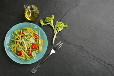 Delicious fresh celery salad served on black table, flat lay. Space for text