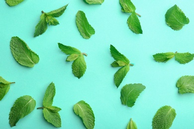 Fresh mint leaves on turquoise background, flat lay