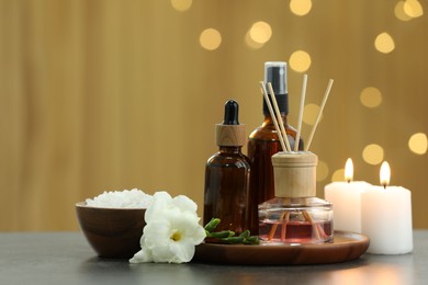 Photo of Composition with different spa products and burning candles on light grey table