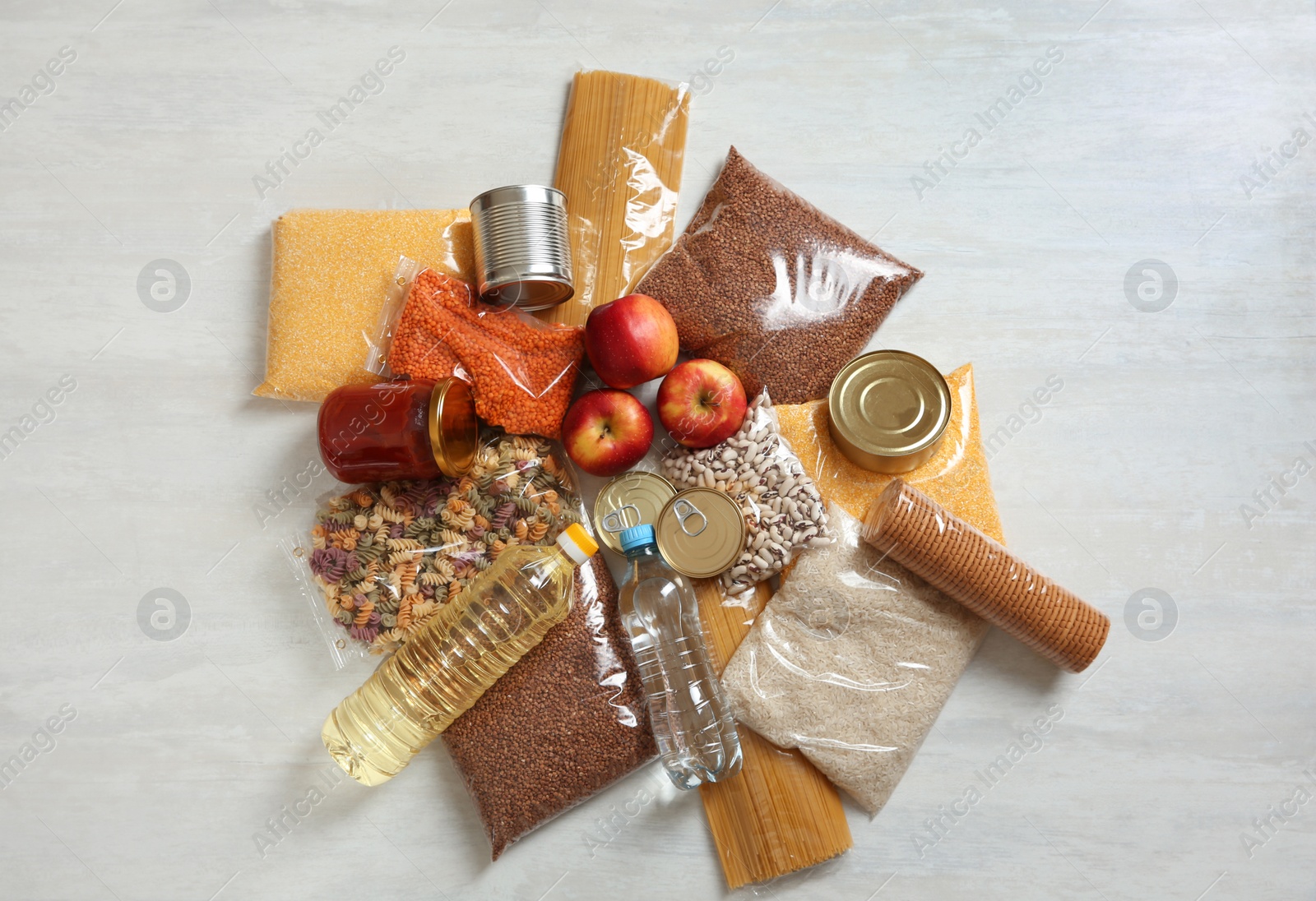 Photo of Many different products on white wooden background, flat lay. Food donation