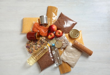 Photo of Many different products on white wooden background, flat lay. Food donation