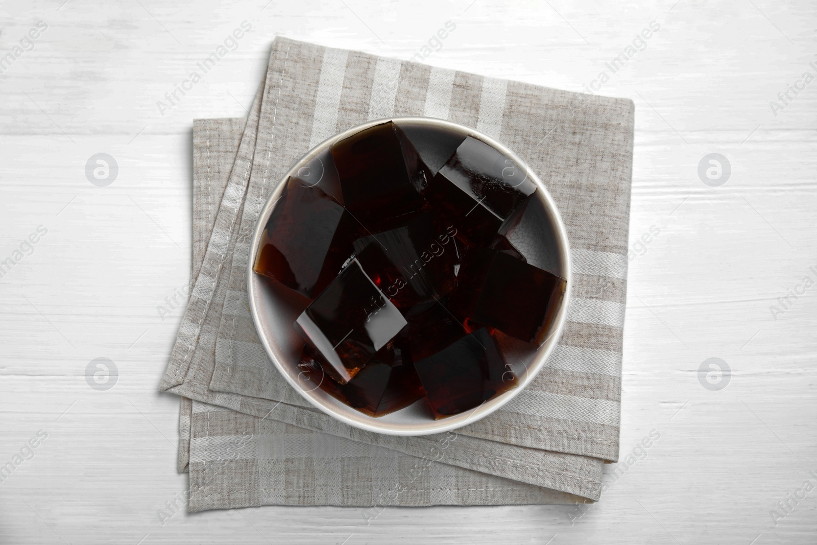 Photo of Delicious grass jelly cubes on white background, top view