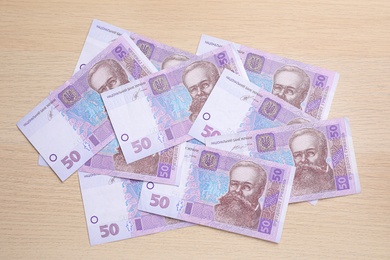 Ukrainian money on wooden background, flat lay