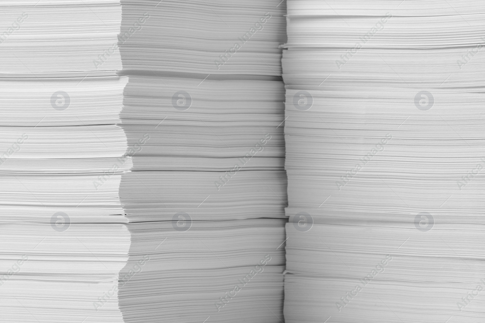 Photo of Stacks of paper sheets as background, closeup