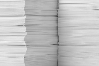 Photo of Stacks of paper sheets as background, closeup