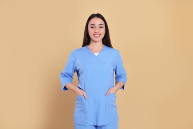 Photo of Portrait of nurse in medical uniform on light brown background