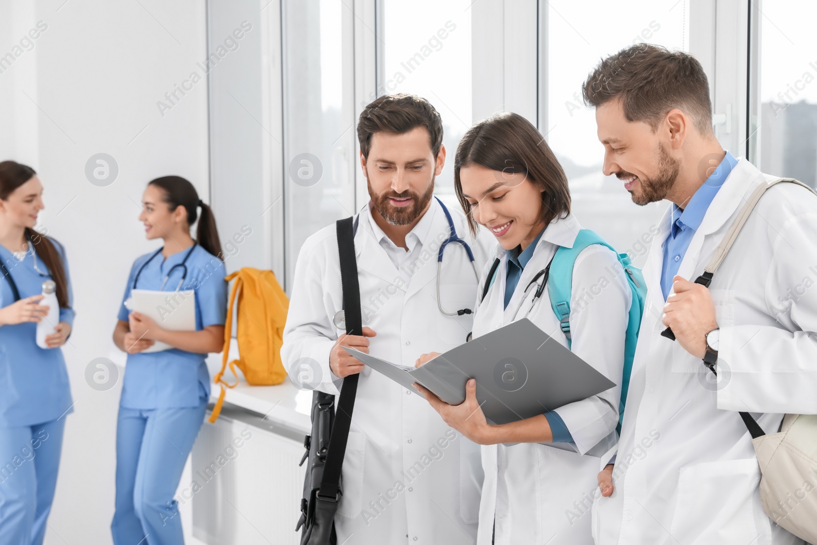 Photo of Team of medical students in college hallway, space for text