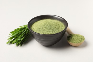 Photo of Wheat grass powder and fresh green sprouts on light table