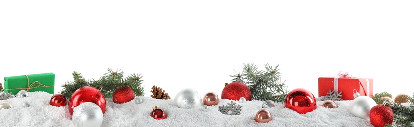 Fir branches, Christmas decoration and snow against white background