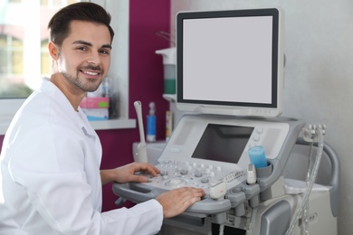 Photo of Sonographer using modern ultrasound machine in clinic