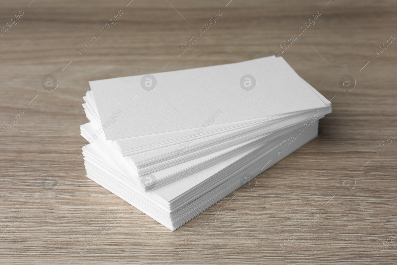 Photo of Stack of blank business cards on wooden table. Mockup for design