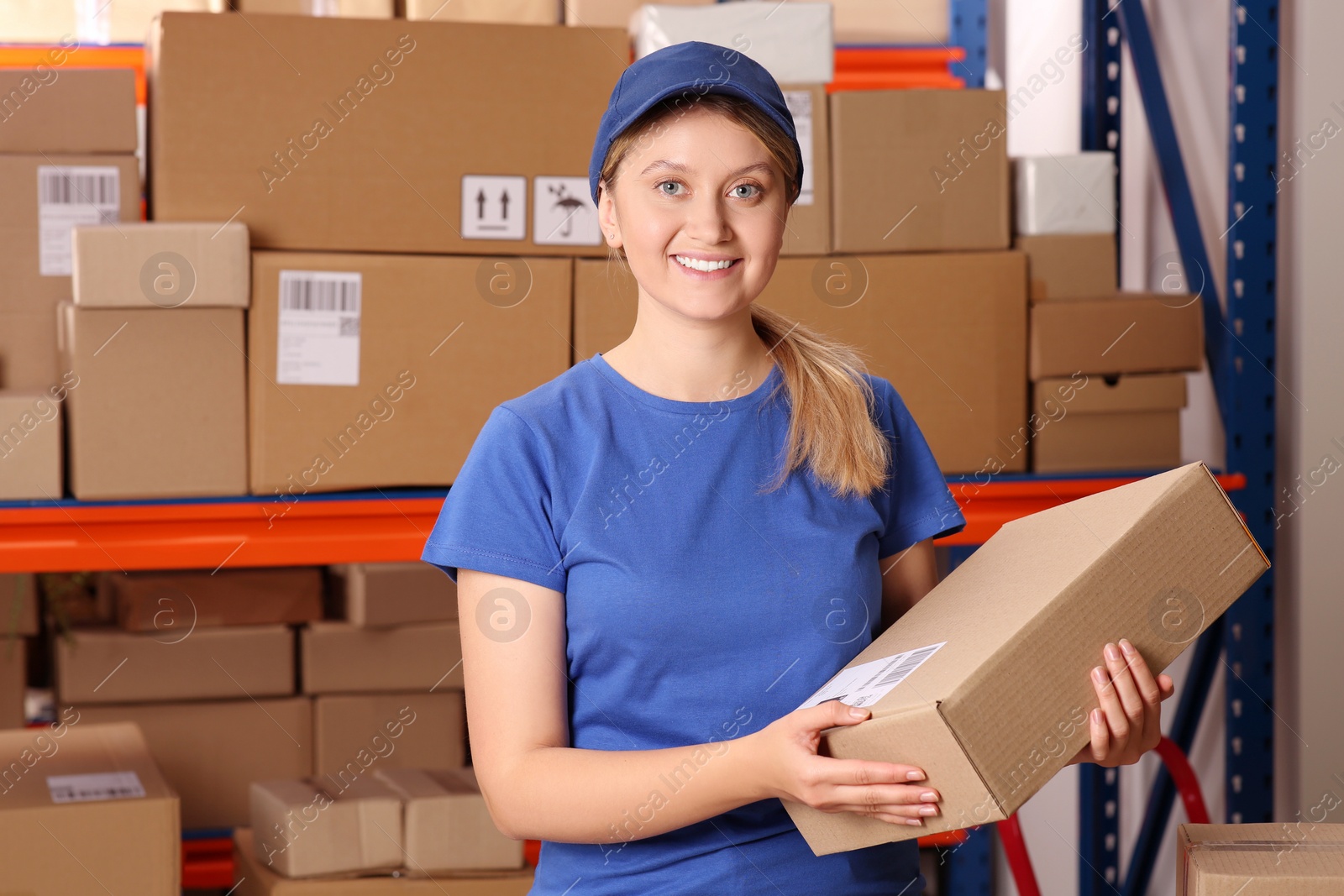 Photo of Post office worker with parcel near rack indoors, space for text