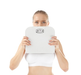 Beautiful young woman with scales on white background. Healthy diet