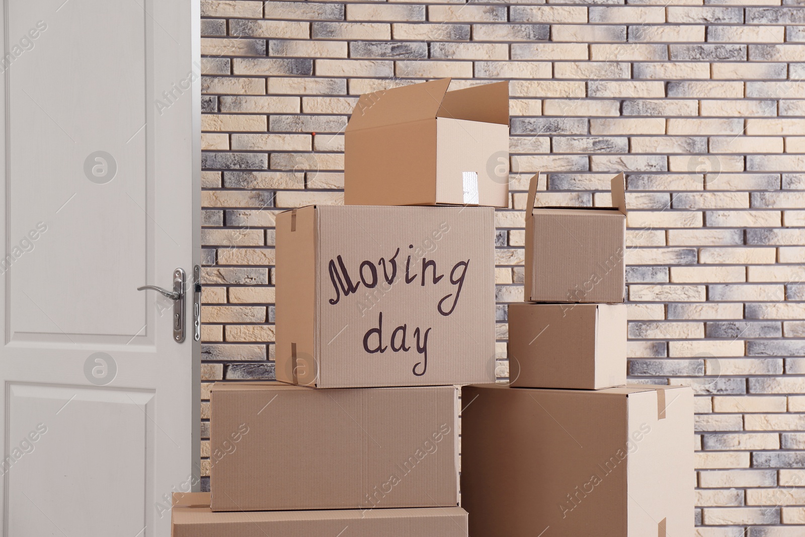 Photo of Pile of moving boxes in empty room