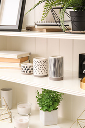 Photo of White shelving unit with different decorative stuff