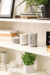 White shelving unit with different decorative stuff