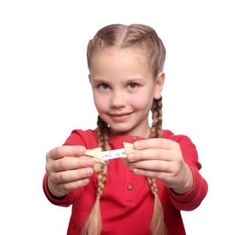 Cute girl holding tasty fortune cookie with prediction on white background