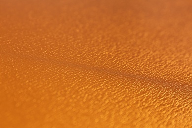 Photo of Golden textured surface as background, closeup view