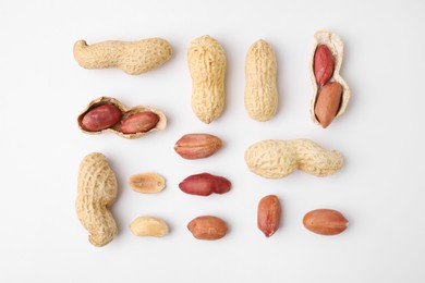 Photo of Fresh peanuts on white table, flat lay