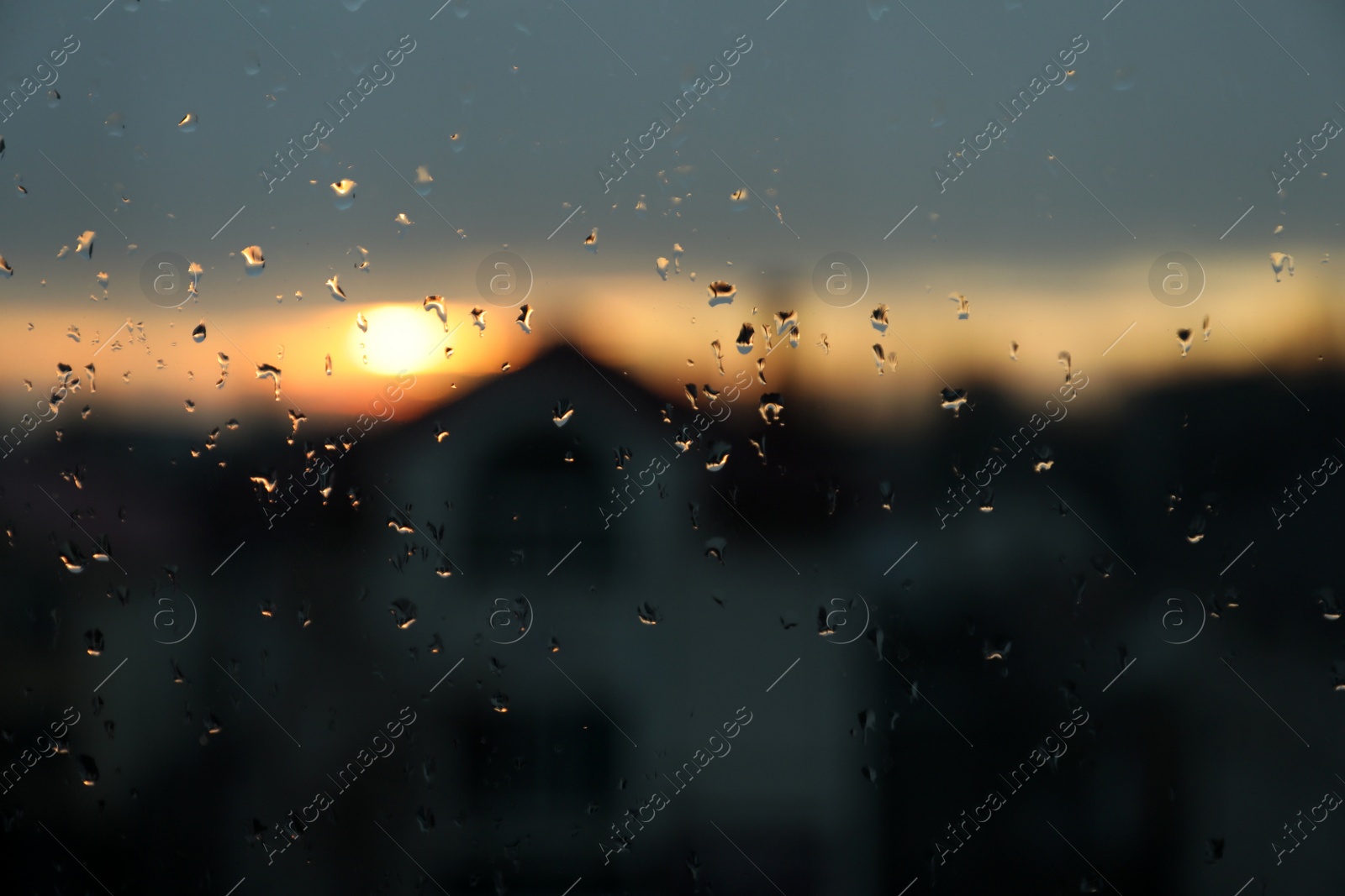 Photo of Blurred view of city through window on rainy day