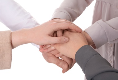 Photo of Group of people holding their hands together on white background, closeup