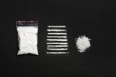 Photo of Flat lay composition with cocaine powder on black background