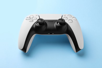 Photo of Wireless game controller on light blue background