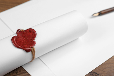 Photo of Document with notary's wax stamp on wooden table, closeup