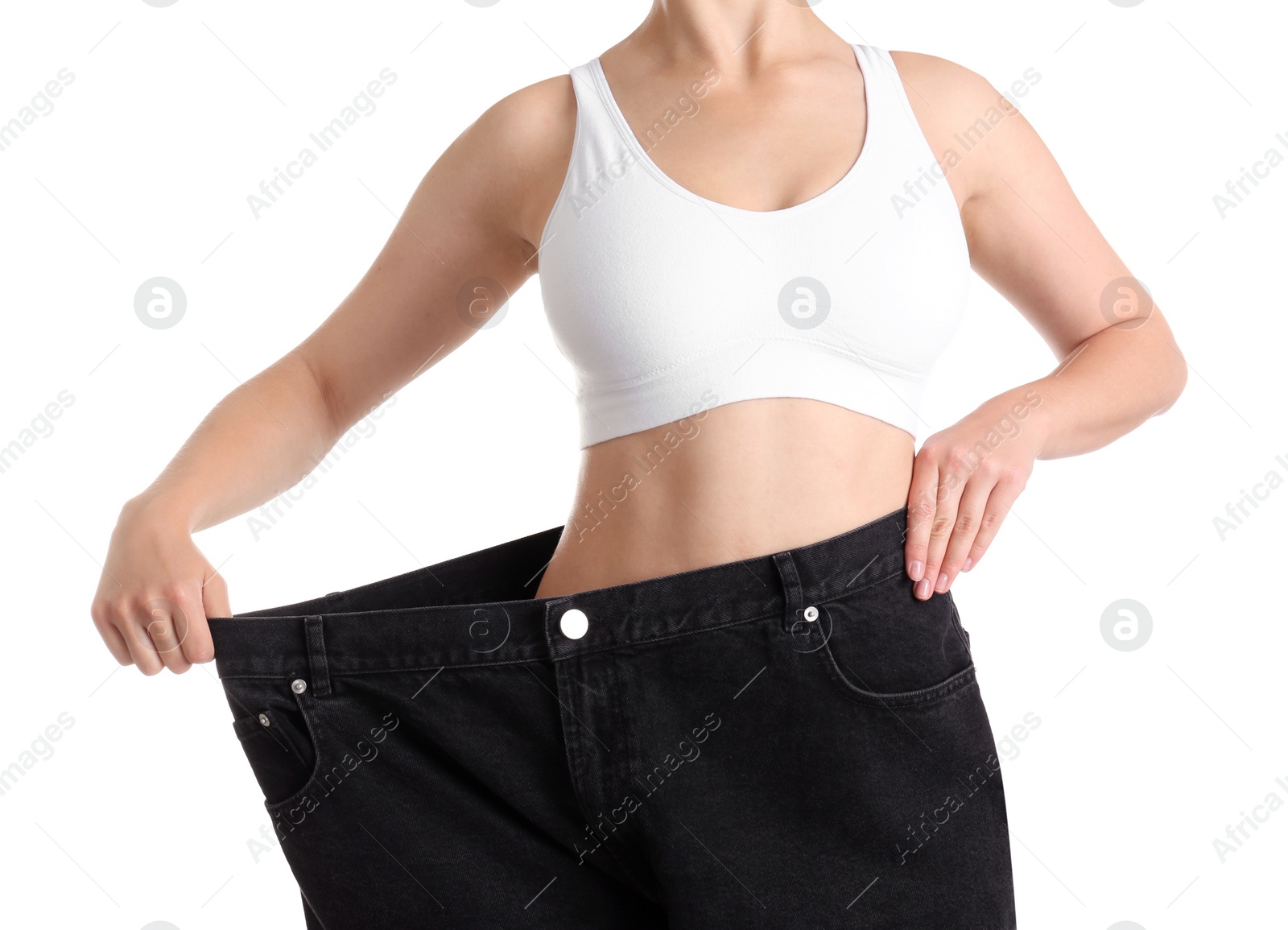 Photo of Young slim woman wearing oversized jeans on white background, closeup