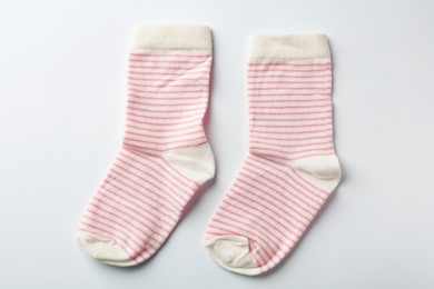 Photo of Cute child socks on white background, top view