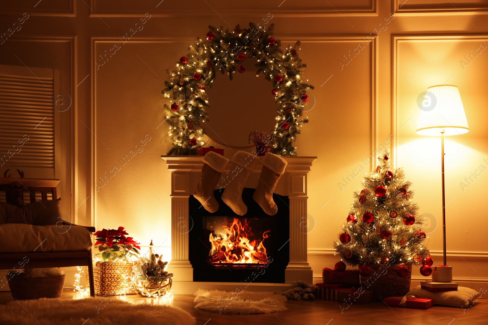 Photo of Fireplace with Christmas stockings in beautifully decorated living room