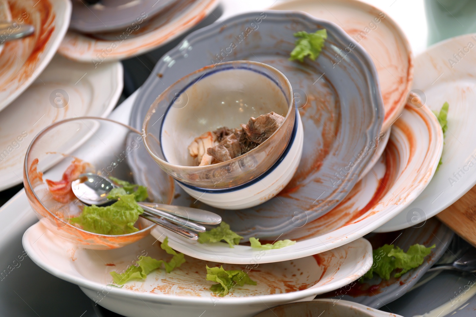 Photo of Many dirty dishes, closeup. Mess after new year party