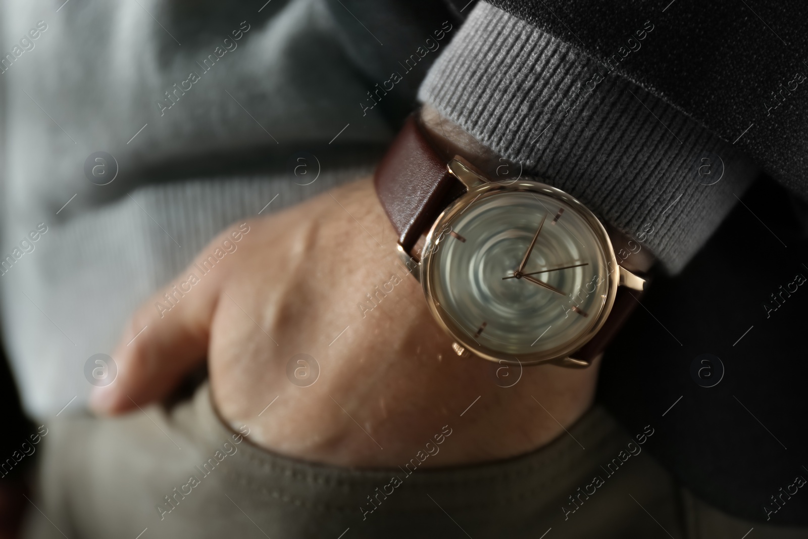 Photo of Man wearing luxury wrist watch with leather band, closeup