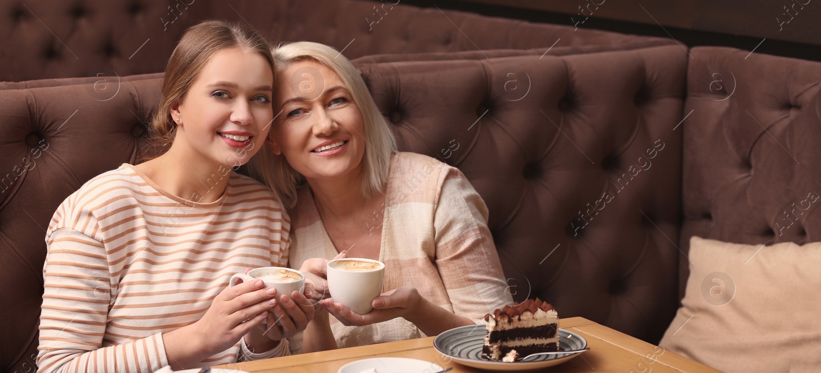 Image of Mother and her adult daughter spending time together in cafe. Banner design