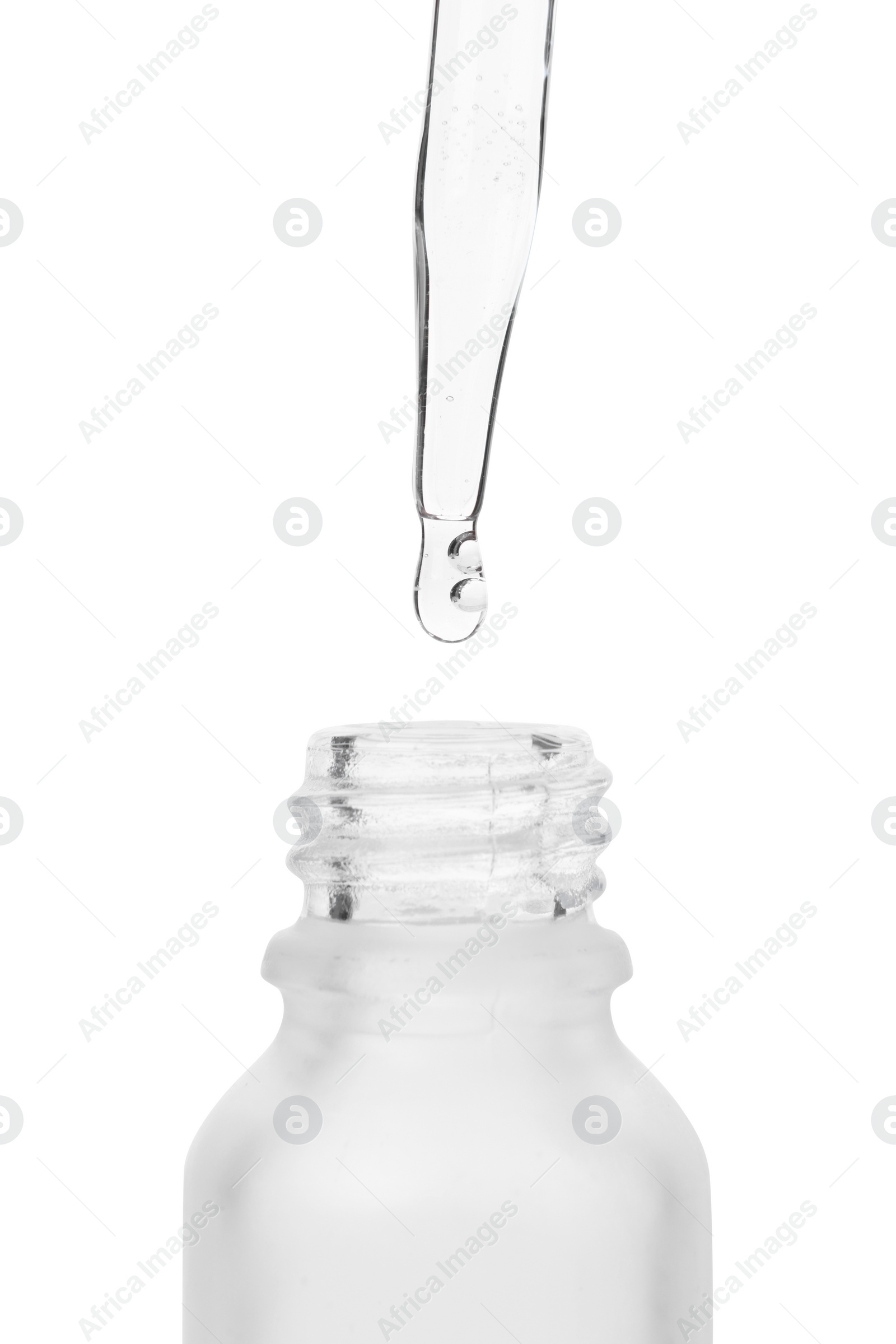 Photo of Dripping liquid from pipette into bottle isolated on white, closeup