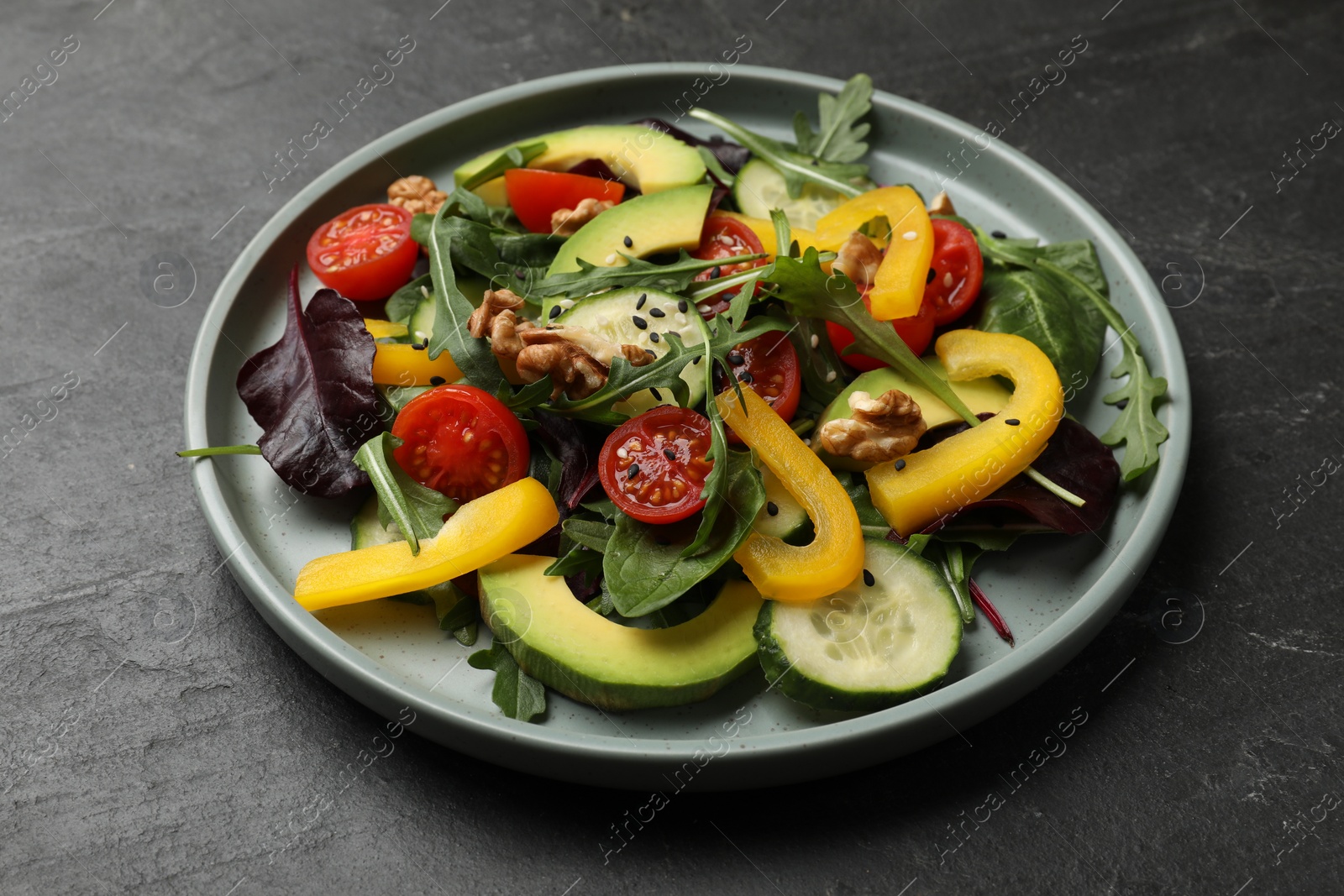 Photo of Balanced diet and vegetarian foods. Plate with different delicious products on black table