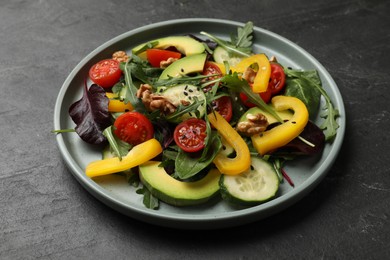 Balanced diet and vegetarian foods. Plate with different delicious products on black table