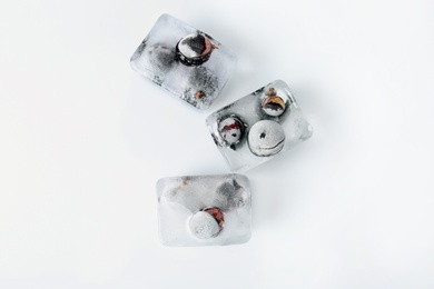 Photo of Fresh berries frozen in ice cubes on white background