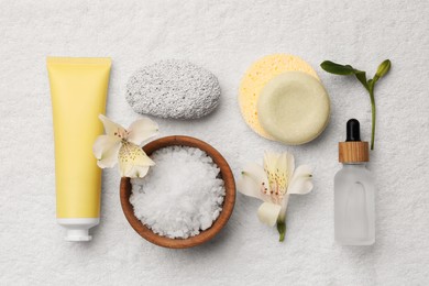 Photo of Flat lay composition with spa products and flowers on white towel