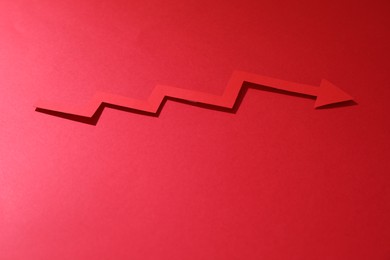 One zigzag paper arrow on red background. Space for text