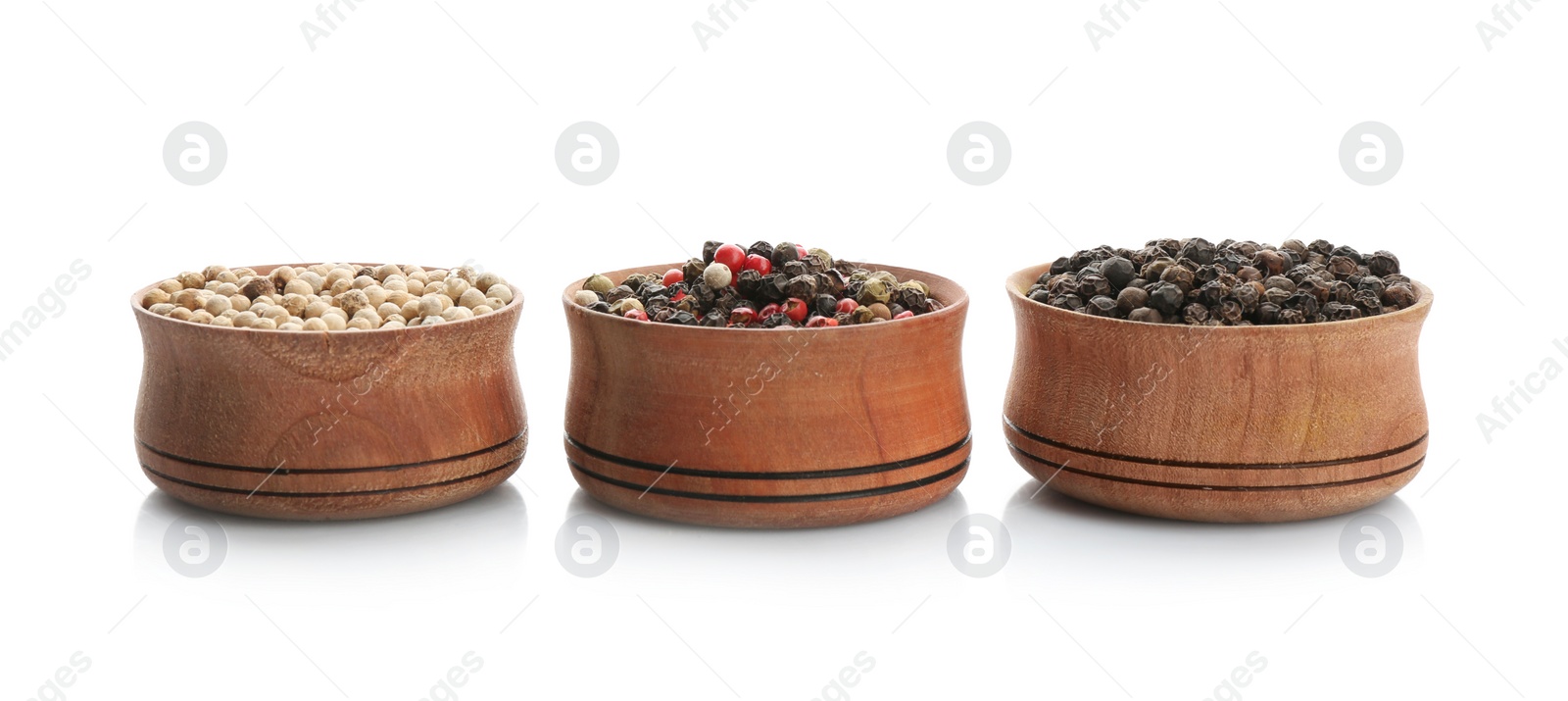 Photo of Bowls with different kinds of pepper grains on white background