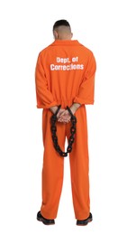 Prisoner in orange jumpsuit with chained hands on white background, back view