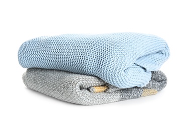 Different stylish knitted plaids on white background