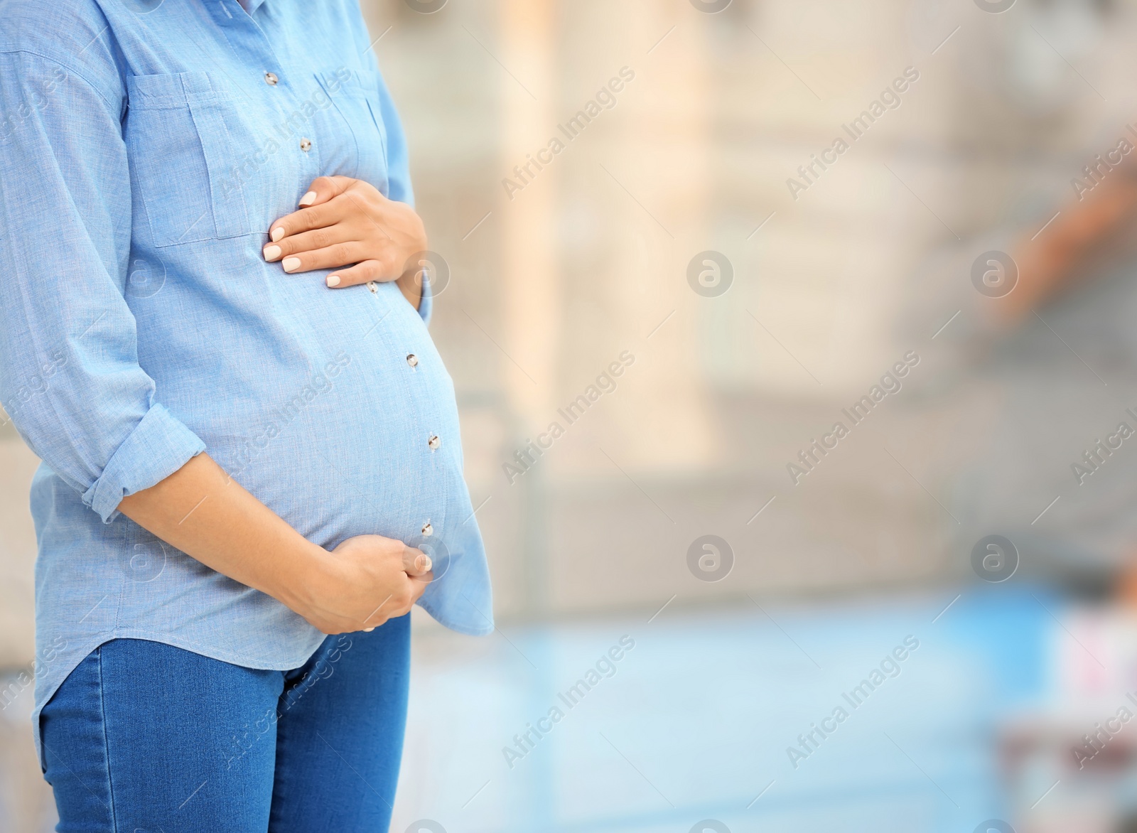 Photo of Beautiful pregnant woman near window at home