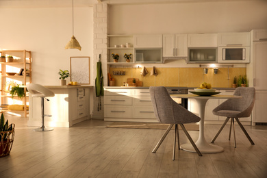 Photo of Modern kitchen interior with stylish white furniture