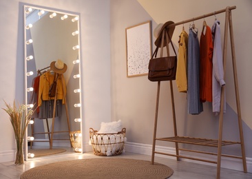 Large mirror with lamps in stylish room interior