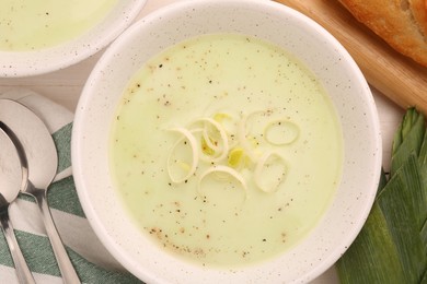 Photo of Bowl of tasty leek soup on table, top view
